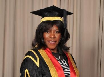 Photograph of Jaki Graham wearing an academic cap and robes.