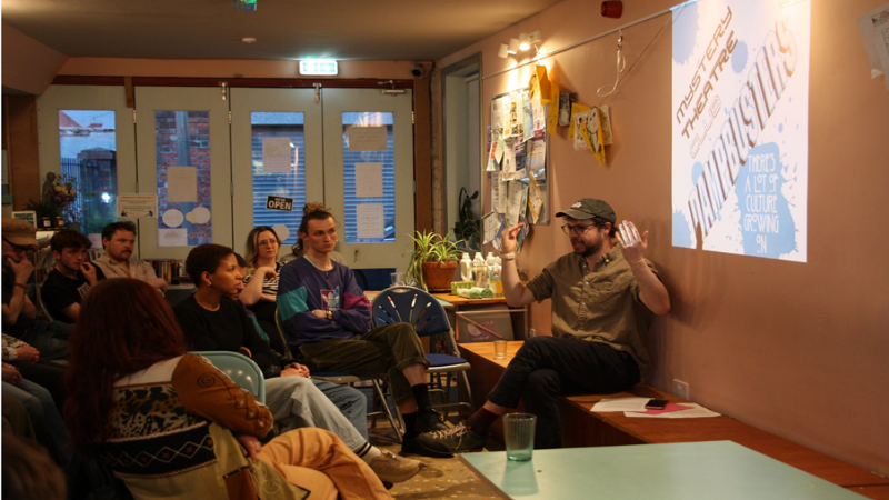 A group of people watching a presentation