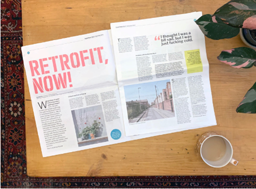 An open newspaper and a cup