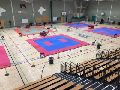 Jitsu arenas prepared in the University sports hall, overseen by rows of seats