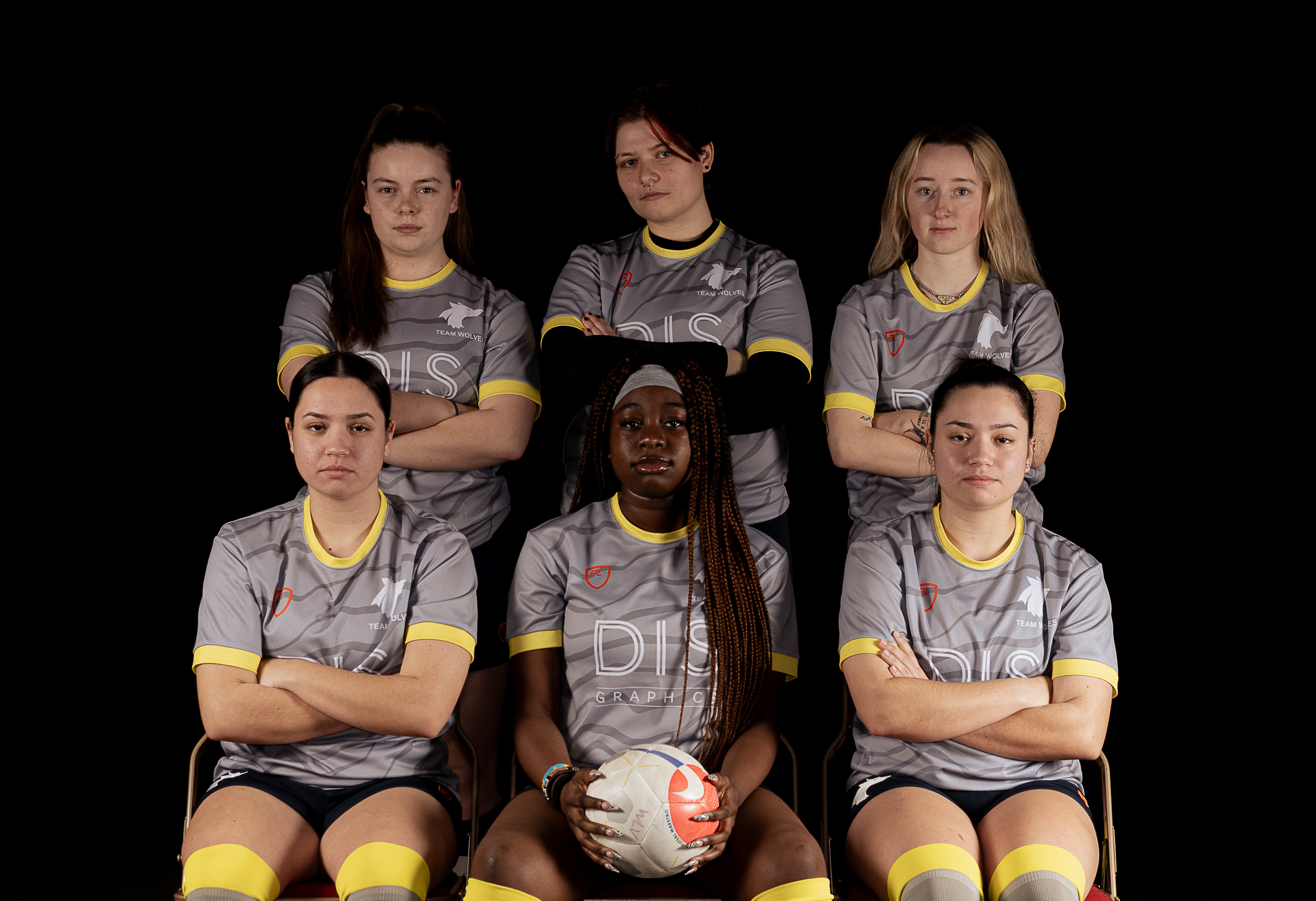 Photograph of the University of Wolverhampton women futsal team for 2023-24, posed together wearing matching grey uniforms with yellow details.