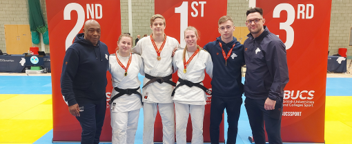 Photograph of medal-winning judoka in white gi.