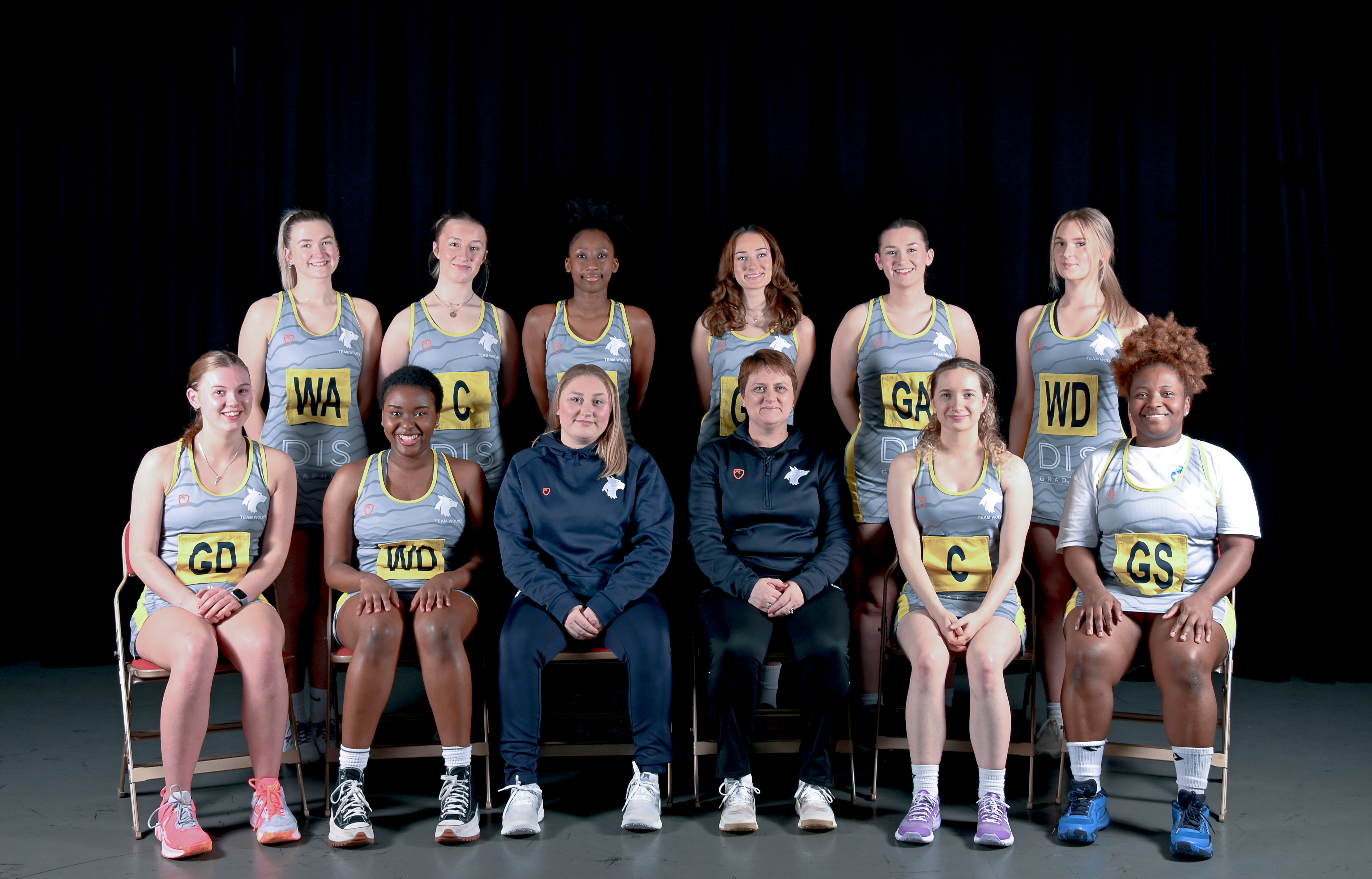 Photograph of the University of Wolverhampton netball team for 2023-24, posed together wearing matching grey uniforms with yellow details.