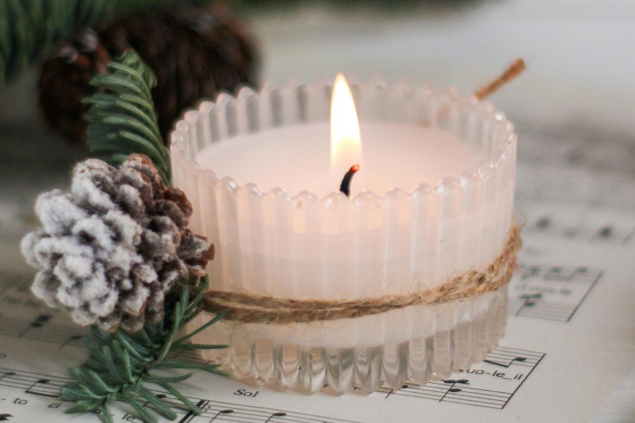 A candle on a Christmas music sheet