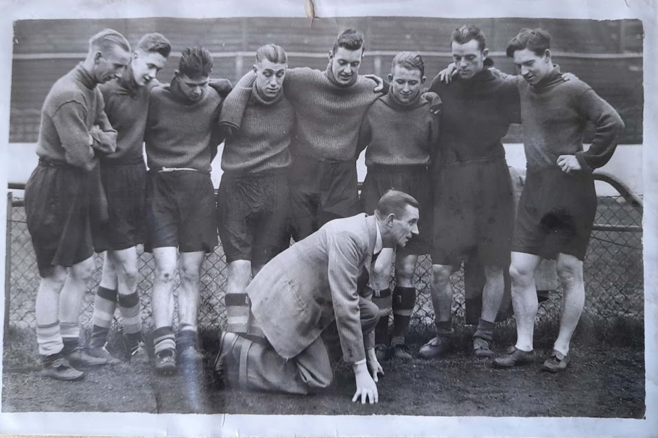 Chelsea players watching a demonstration by their trainer