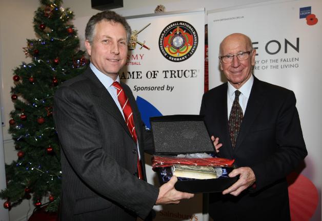 General Sir Nicholas Carter, GCB, CBE, DSO, ADC Gen, Chief of the General Staff makes presentation to Sir Bobby Charlton at The Game of Truce